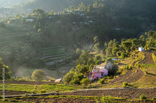 Beautiful landscape of a village based in mountains captured during sunset. View of terrace farms with the crops. photo