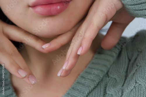 Hands with manicure and lips of a girl