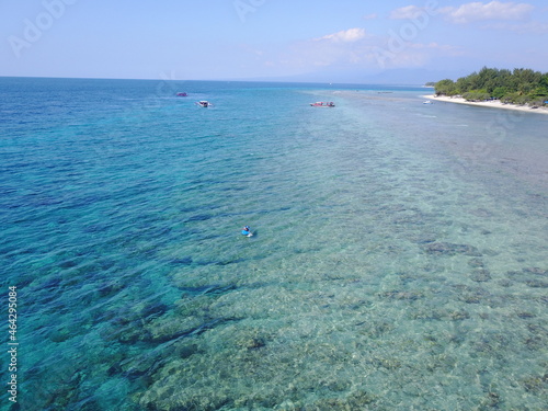 island beach with sky summer nature explore corals ocean sea water Bali Indonesia boat guy man surf board 