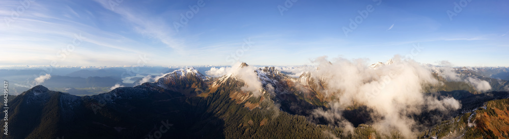 Aerial Panoramic View of Canadian Rocky Mountains with snow on top during Fall Season. Nature Landscape located near Chilliwack, East of Vancouver, British Columbia, Canada. Nature Background Panorama