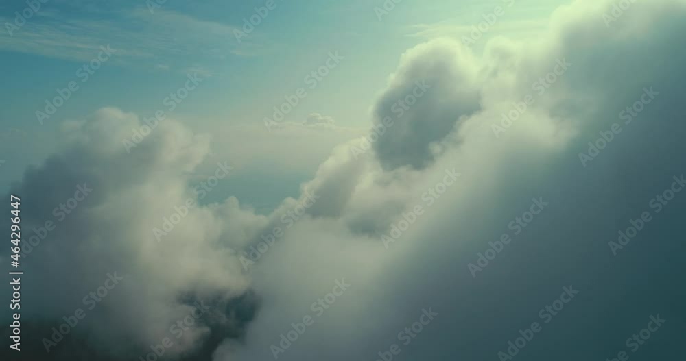 Aerial fly above clouds with blue sky in backgroubnd on beautiful sunny day Aerial fly above clouds with blue sky in backgroubnd on beautiful sunny day