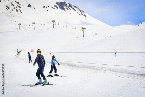 Caucasian ski instructor teaching teenager boy to ski in Gudauri ski resort. Ski holiday in Georgia
