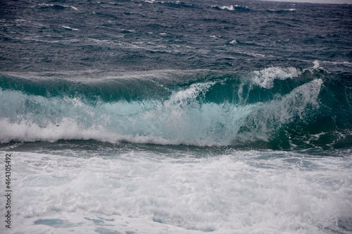Rolling wave crashing on rocky coast.wave breaking on the shore.A big wave overlaps the coast of the Croatian island of Losinj. 