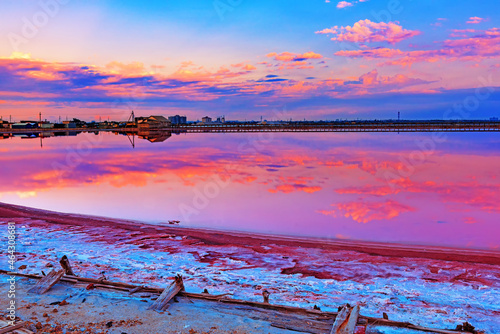 the pink salt lake reflects the heavenly landscape