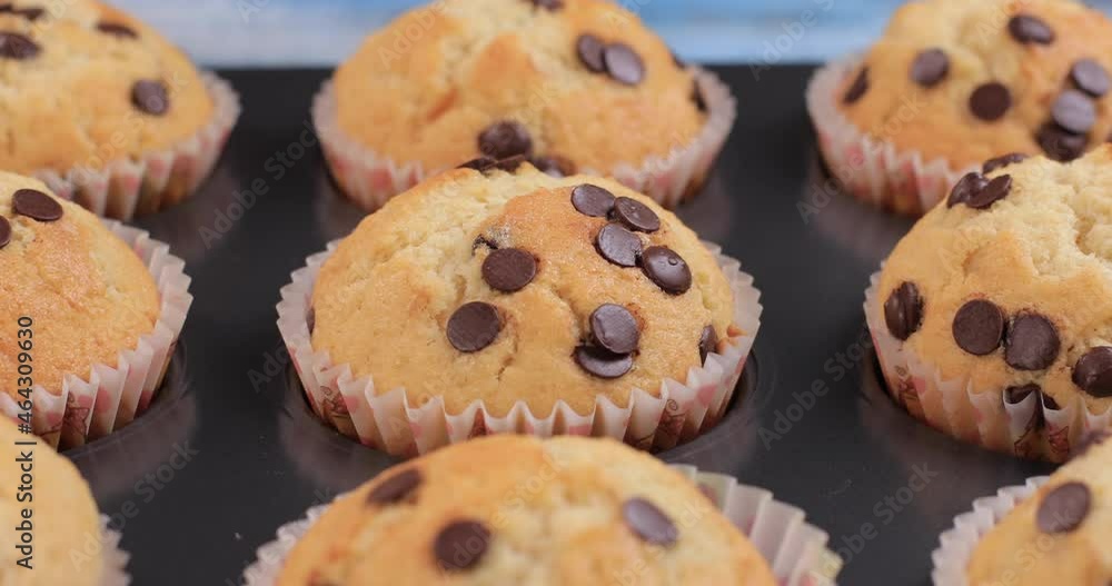 Muffins with chocolate chips on wooden background. Healthy ingredients sweets concept. Dolly shot 4k Muffins with chocolate chips on wooden background. Healthy ingredients sweets concept. Dolly shot 4k