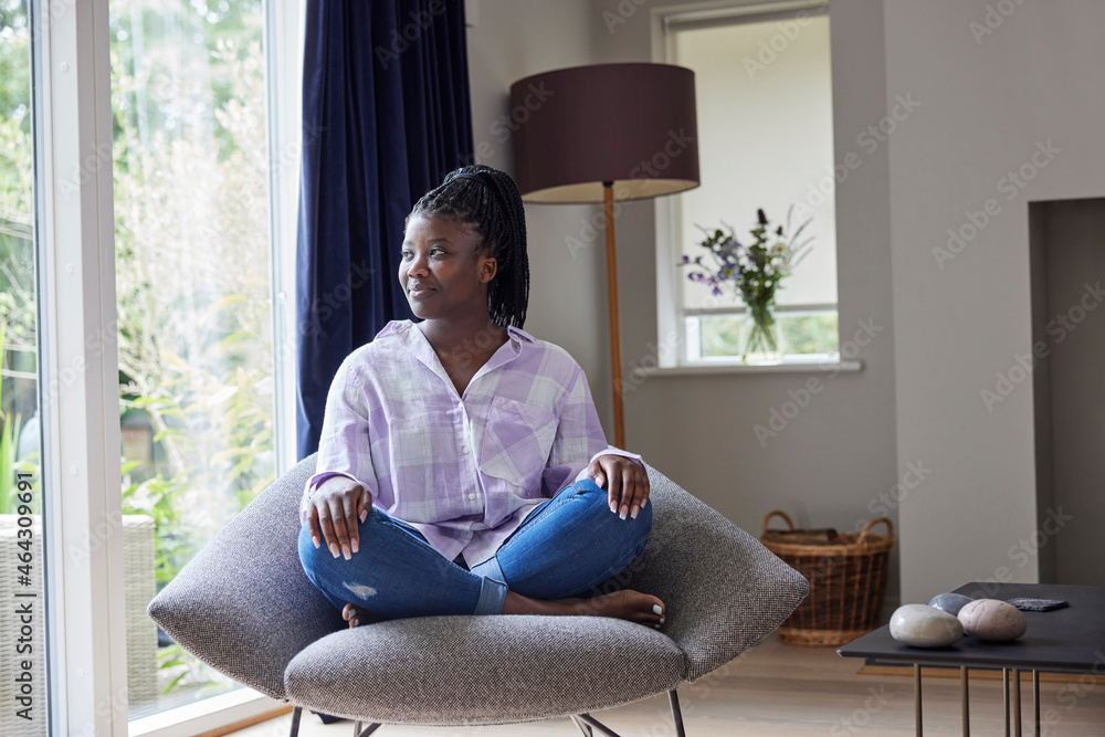 Peaceful Teenage Girl Sitting In Chair At Home Looking Out Of Window Peaceful Teenage Girl Sitting In Chair At Home Looking Out Of Window