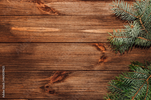 Christmas background with sprig of fir on wooden boards.