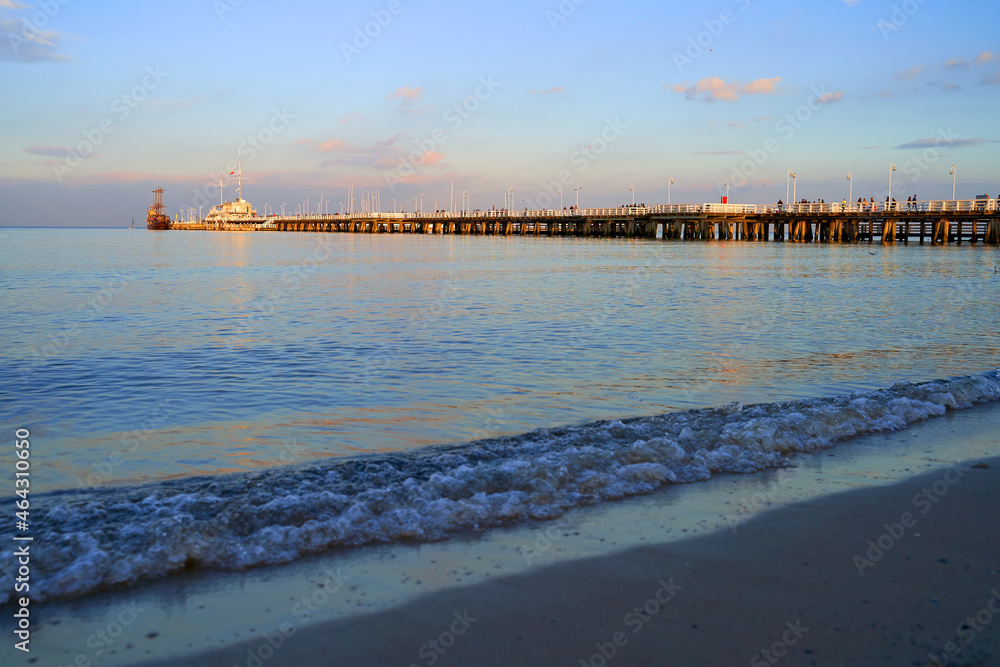Sopot Pier at dusk with a wooden ship