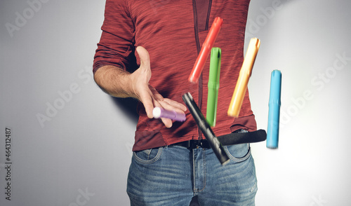 Man throwing coloured pens