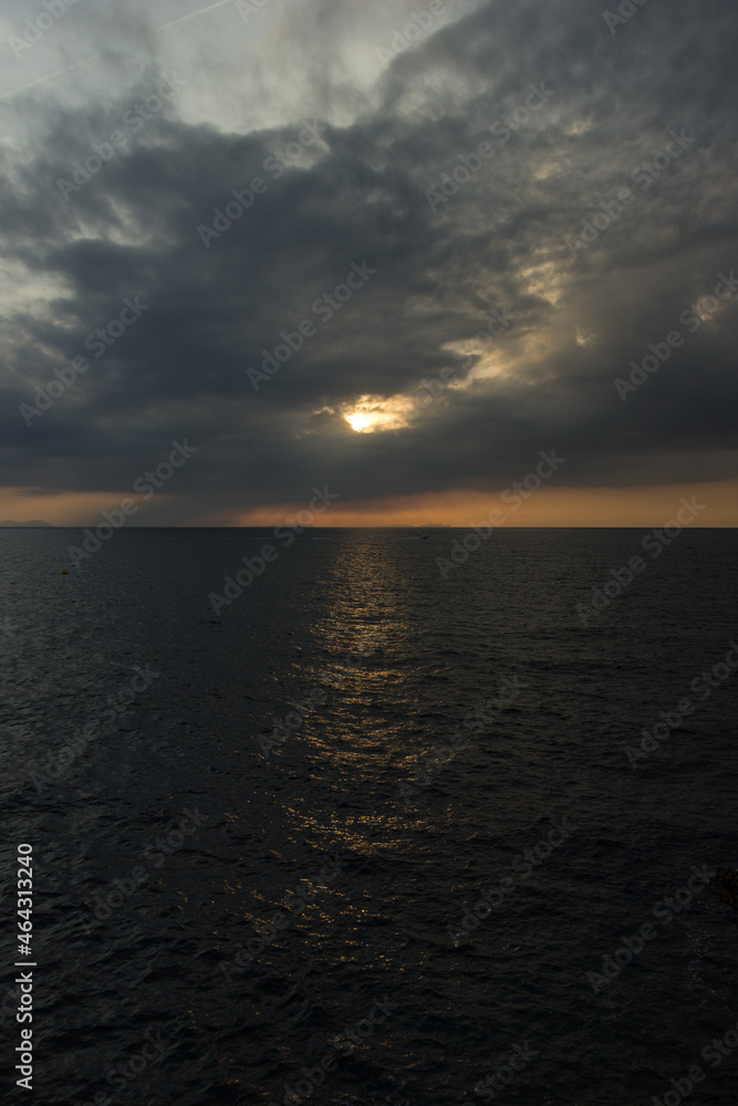 Cloudy sunset over the dark sea