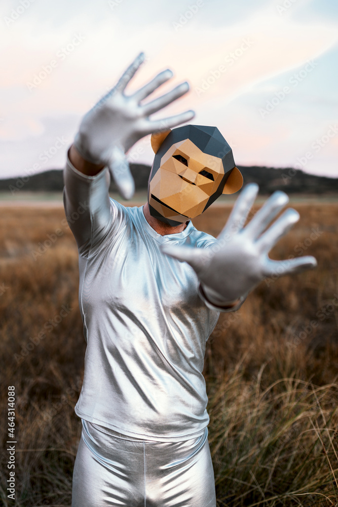 Person in monkey mask showing hands with bent thumbs Person in monkey mask showing hands with bent thumbs