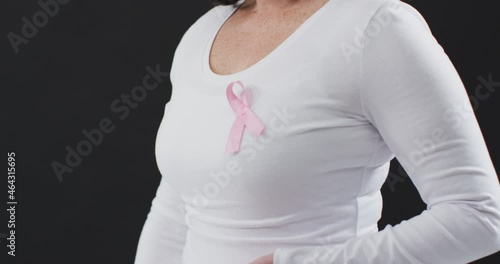 Wallpaper Mural Mid section of a woman showing the pink ribbon on her chest against black background Torontodigital.ca