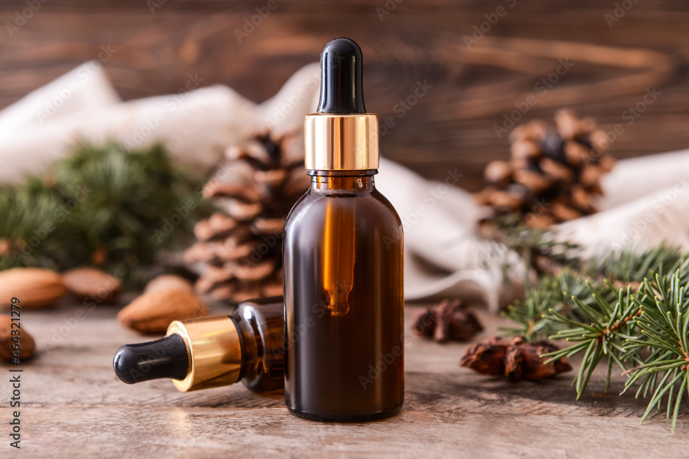 Bottles of essential oils on wooden background Bottles of essential oils on wooden background