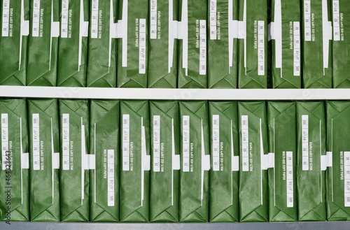 Foto Copy paper reams with generic brand green packaging stacked up in rows on office shelves