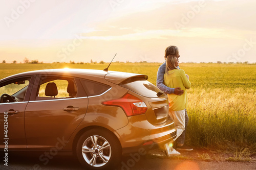 Happy mature couple near car in countryside