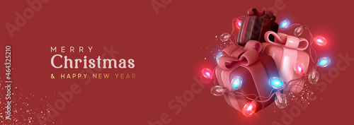 Christmas gift box. Presents with surprise, wrapped in bright light burning garland. Xmas festive background with realistic 3d design element. Happy New Year. Horizontal banner, header for website