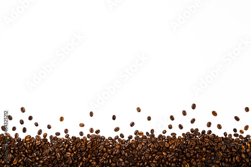 Roasted coffee or espresso beans border or frame against white background. Table top view, flat lay, copy space.