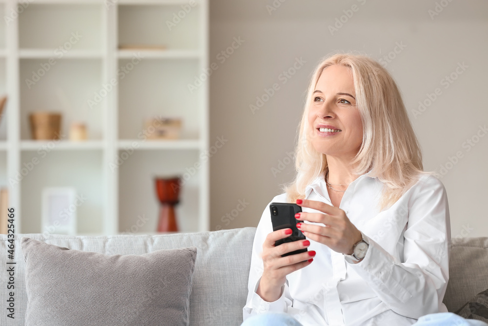 Beautiful mature woman using mobile phone at home Beautiful mature woman using mobile phone at home