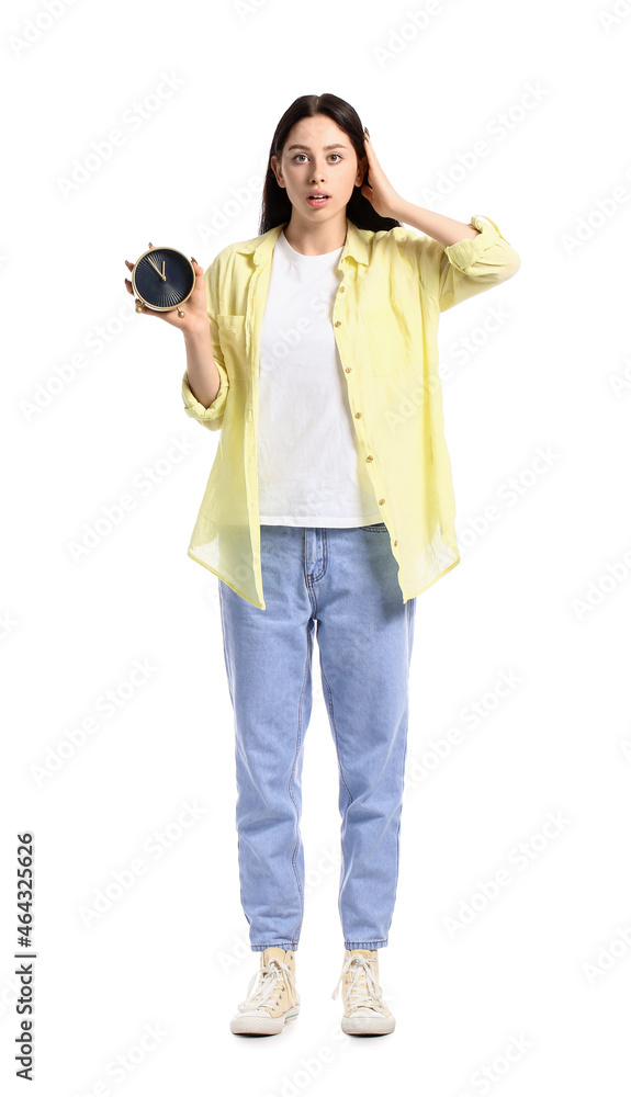 Shocked teenage girl with alarm clock on white background Shocked teenage girl with alarm clock on white background