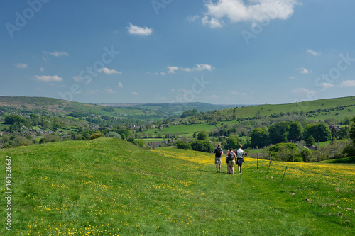 Walkers descendng grassy path from Eyam to Stoney Middleton, Hope Valley, Peak District, UK
