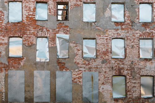building facade with boarded up windows .