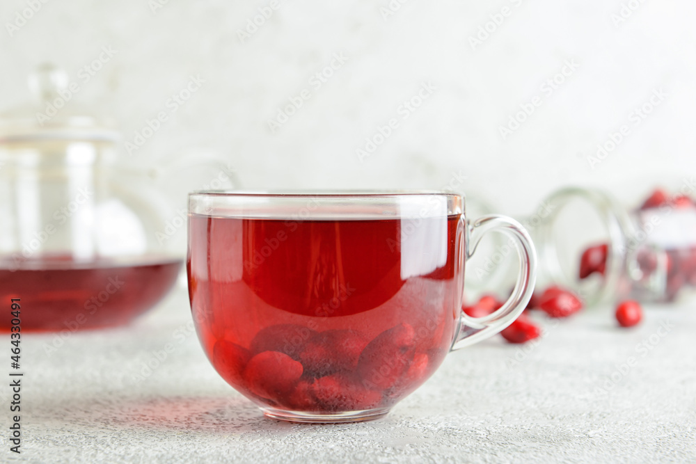 Cup of healthy dogwood berry drink on grey background Cup of healthy dogwood berry drink on grey background