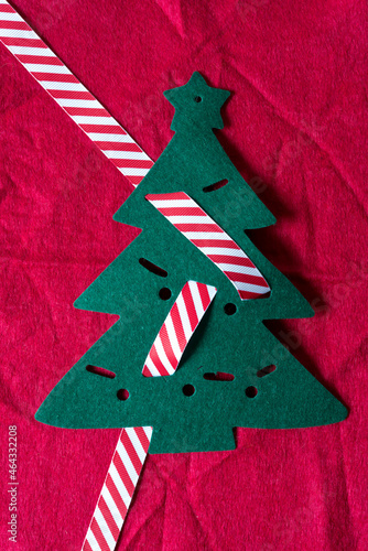 christmas tree with striped ribbon on red flet photo