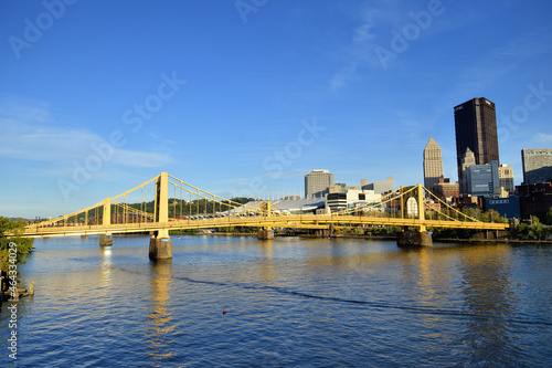 Bridges crossing the Allegheny River in Pittsburgh reflecting the early evening sun. In the foreground is the Andy Warhol Bridge or Seventh Street Bridge.