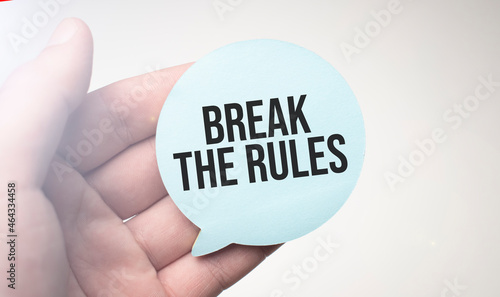 Businessman holding speech buble paper with a message Break the Rules