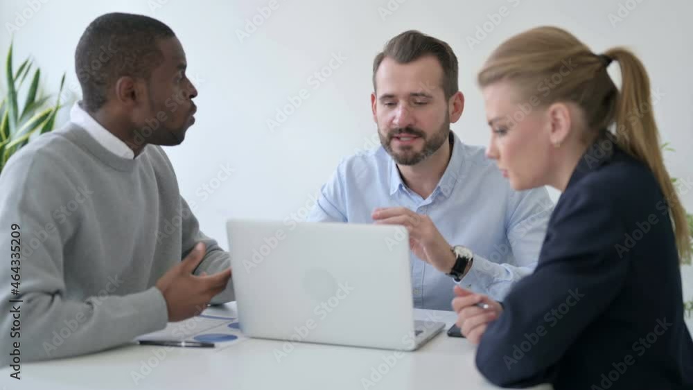 Male and Female Business People Arguing while using Laptop in Office Male and Female Business People Arguing while using Laptop in Office