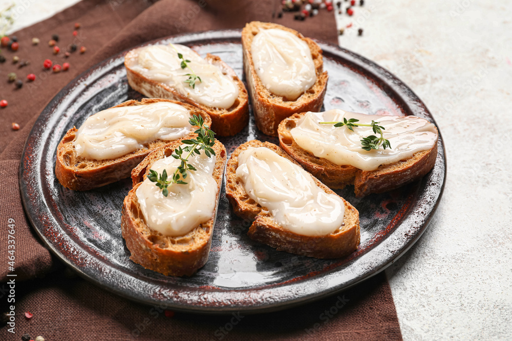 Plate of bread with lard spread on light background Plate of bread with lard spread on light background