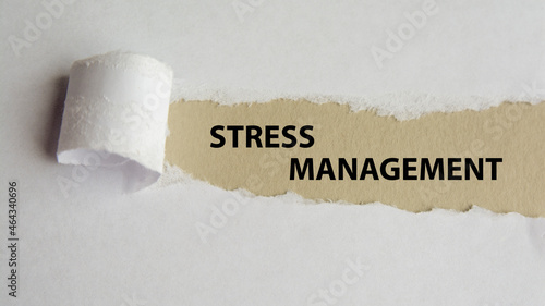 stress management. words. text on gray paper on torn paper background
