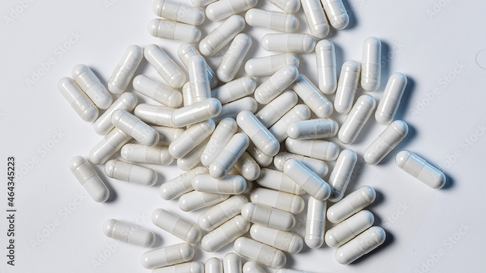 White capsules close-up. Medicines. Macrophotography of medicines. White capsules close-up. Medicines. Macrophotography of medicines.