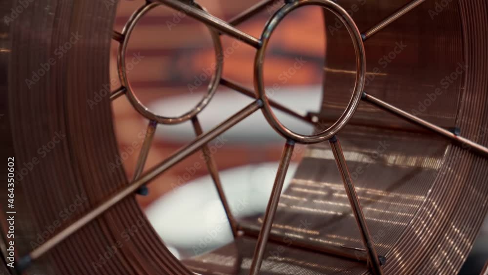 Rotation of bobbin with copper wire for welding. Rotation of bobbin with copper wire for welding.