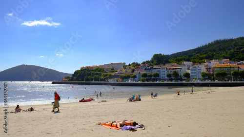 People relaxing at Cedeira beach on a sunny day in Galicia Rias Atlas, Spain photo