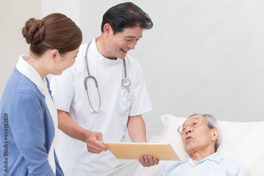 在宅医療する医者と看護師とシニア男性患者 在宅医療する医者と看護師とシニア男性患者