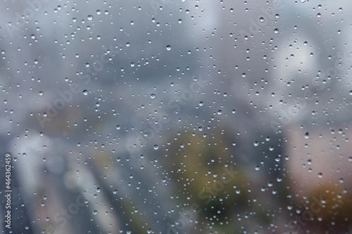 Water droplets in a close up on a high office building with city landscape in the background