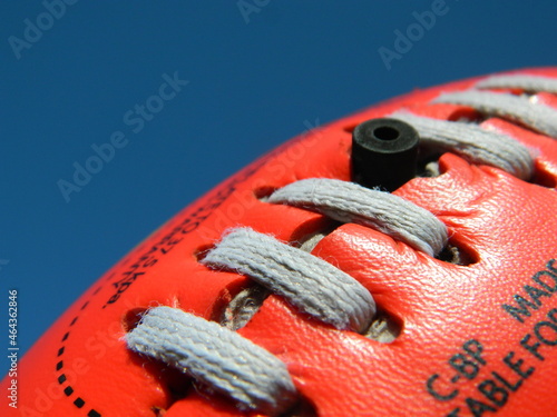 Close up of an Australian rules football on a blue sky background photo