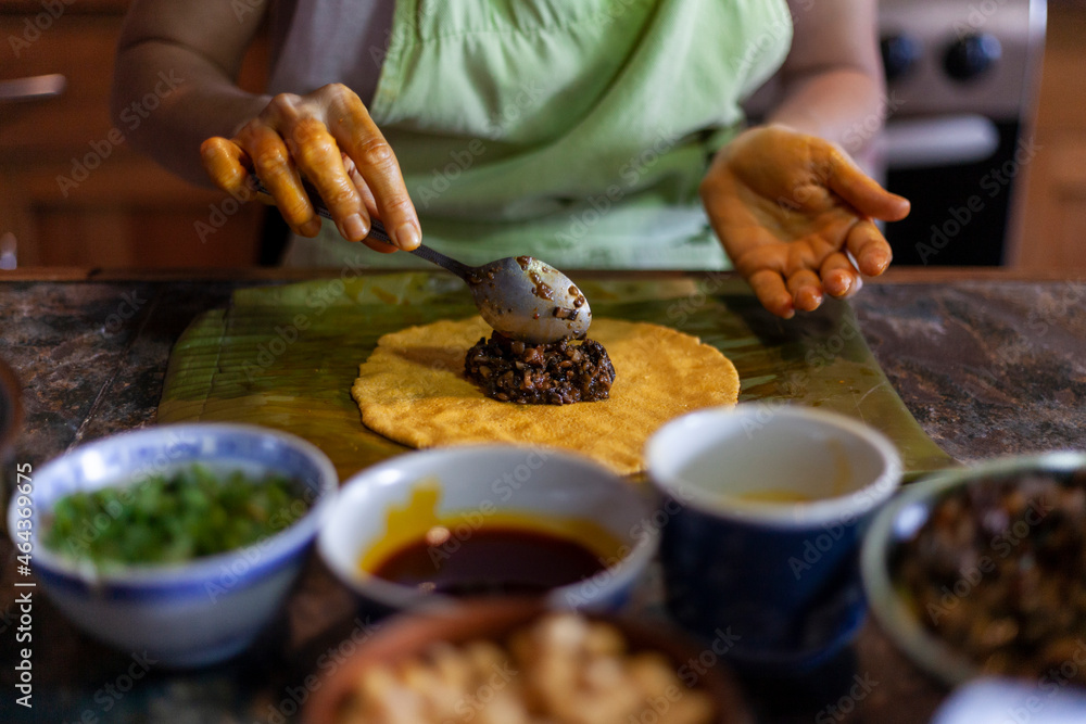 Close up of hands preparing hallaca or tamale. Traditional food concept