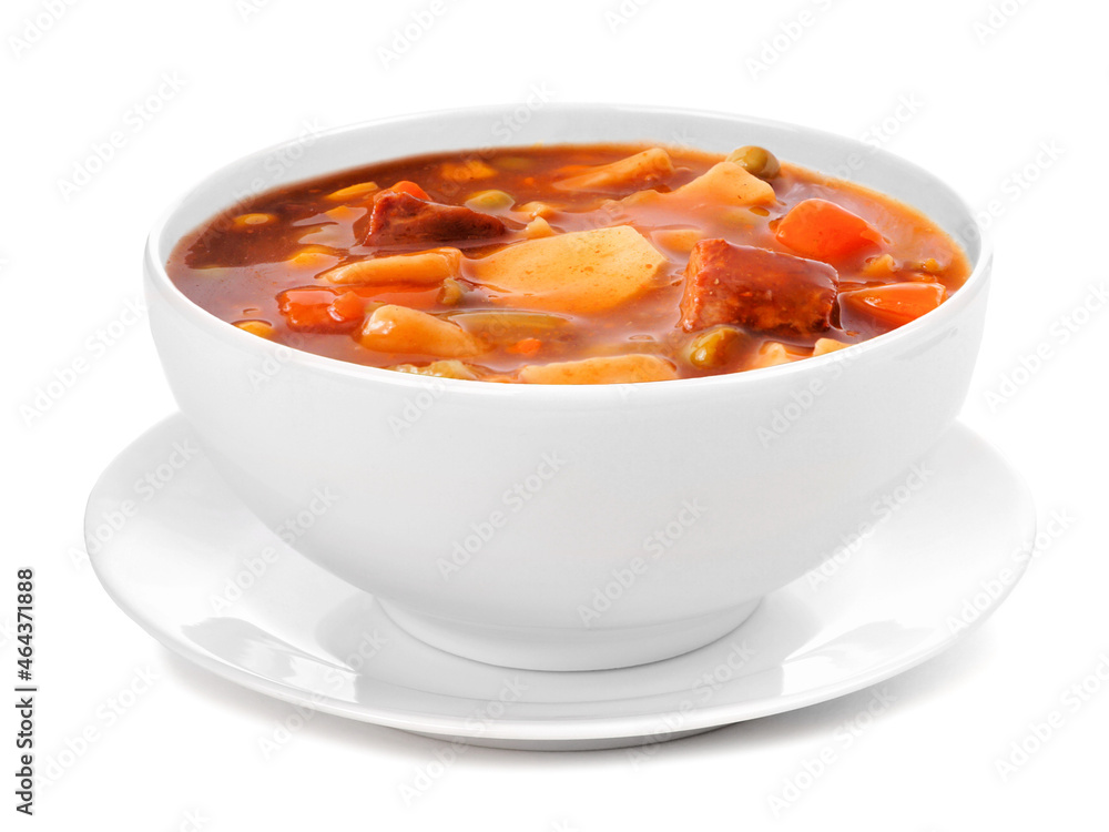 Homemade beef vegetable soup in a white bowl with saucer. Side view isolated on a white background. Homemade beef vegetable soup in a white bowl with saucer. Side view isolated on a white background.