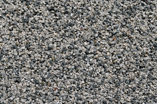 Fine gravel wall texture with pieces of different colors closeup