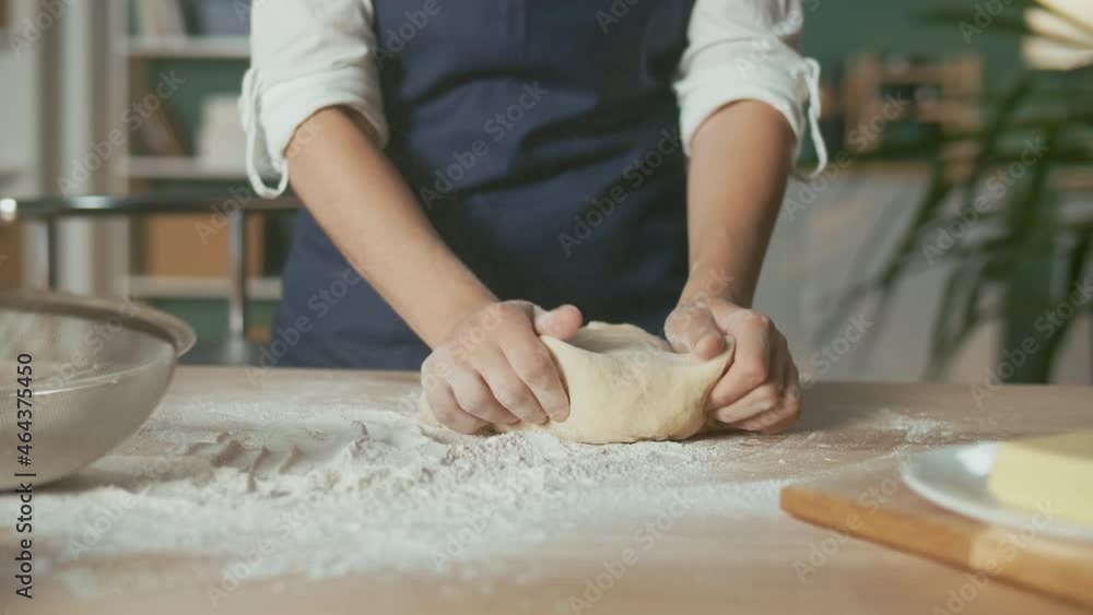 Professional Chef Kneads Dough for Baking on a Wooden Kitchen Table. The Process of Making a Beautiful Dough. Homemade Cakes for a Pastry Coffee Shop. Close-up. Professional Chef Kneads Dough for Baking on a Wooden Kitchen Table. The Process of Making a Beautiful Dough. Homemade Cakes for a Pastry Coffee Shop. Close-up.