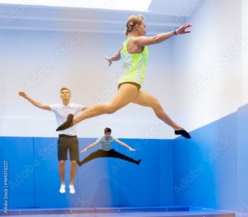 Portrait of positive athletic girl during training in trampoline center. Sport lifestyle concept.. © JackF