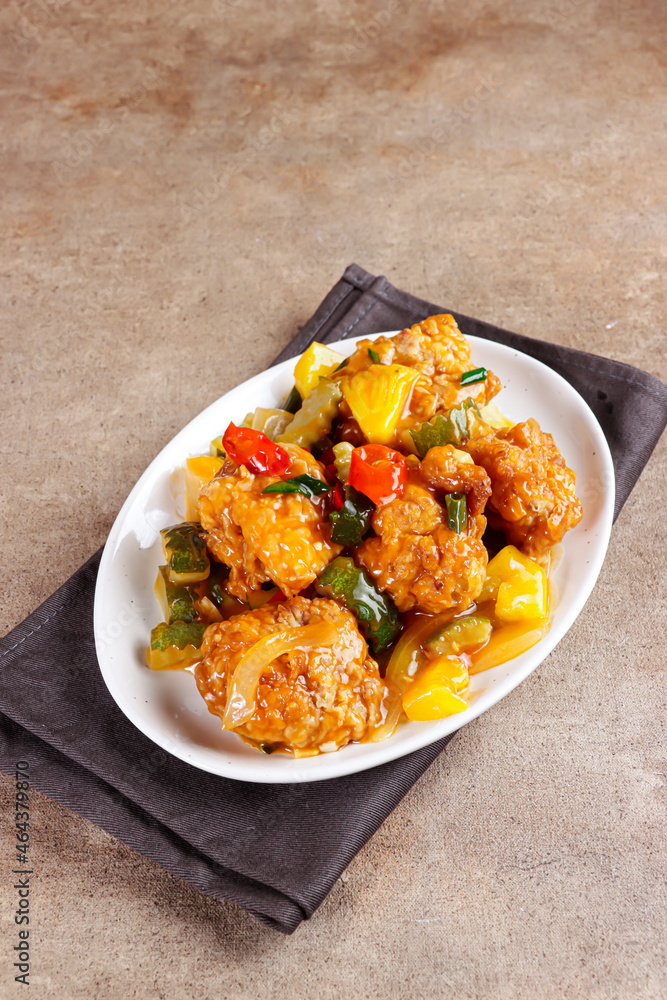 Ayam Koloke or Kuluyuk Chicken, is a Chinese Indonesian dish made from crispy chicken seasoned with red sweet and sour pineapple sauce. Popular as Ayam Asam Manis