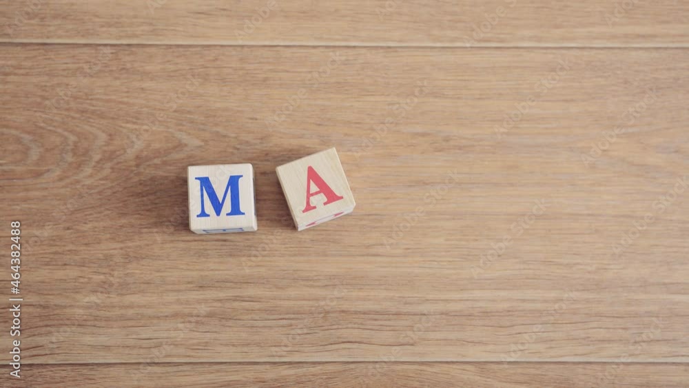 Baby writes the word mom from cubes Baby writes the word mom from cubes