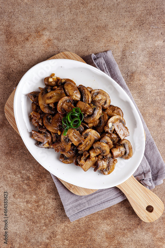 Tumis jamur kancing or Oseng jamur kancing. Mushrooms sauteed in a plate. photo