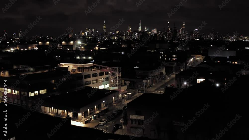 Slow epic aerial tilt down from legendary Manhattan skyline down to industrial Brooklyn rooftops at the end of sunset Slow epic aerial tilt down from legendary Manhattan skyline down to industrial Brooklyn rooftops at the end of sunset