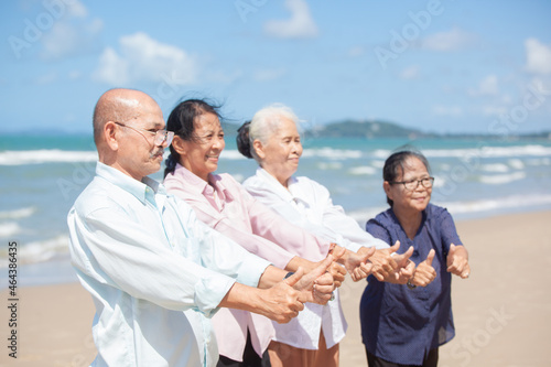 Asian Family Having Fun On Beach. Senior Woman On Holiday On Beach. family holiday and travel summer beach concept