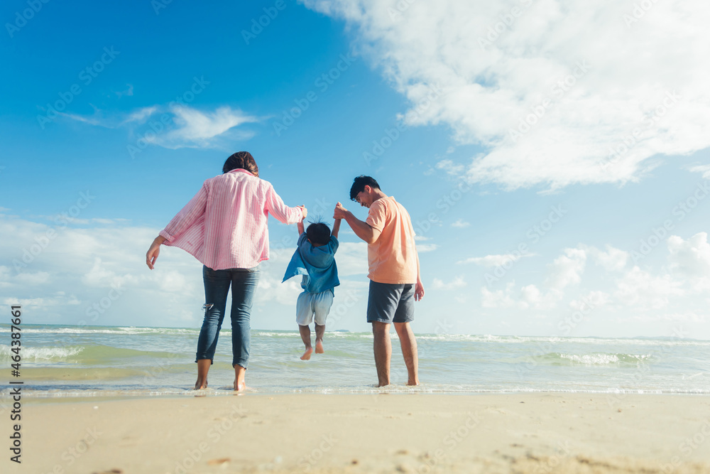 Happy young family Asian have fun on beach. Young family on vacation have a lot of fun Happy young family Asian have fun on beach. Young family on vacation have a lot of fun