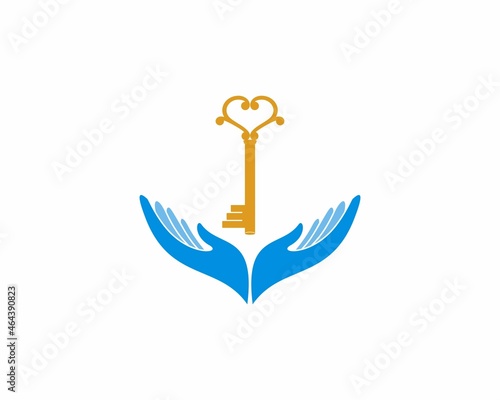 Golden key on the hand care logo